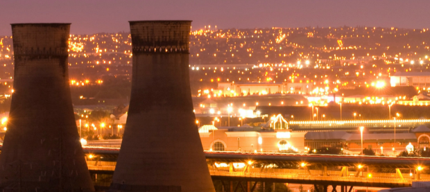 View of Sheffield at night with cooling towers in the foreground.