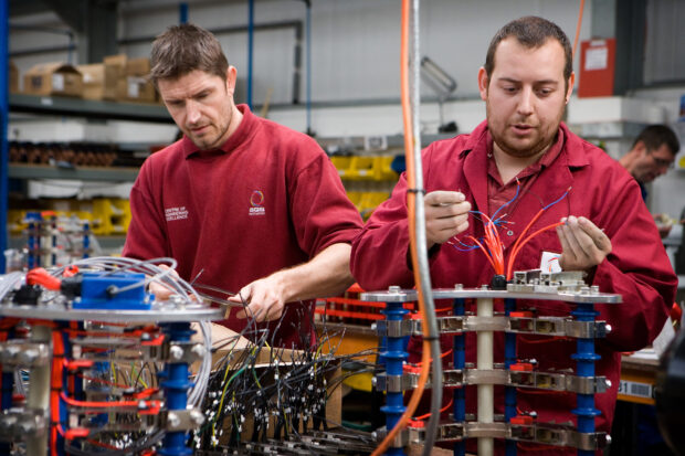 Engineers looking at electric wiring