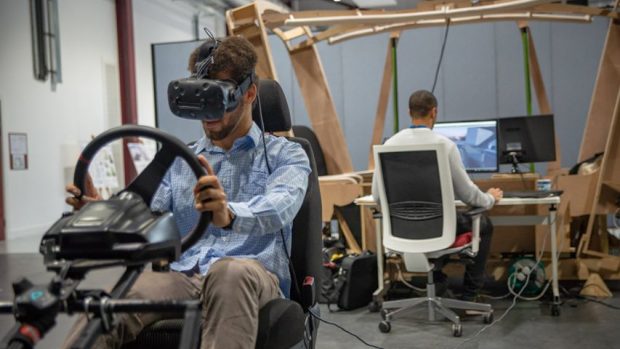 Man test driving car wearing a virtual reality head set